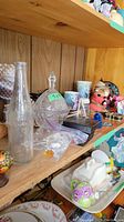 Shelf with vintage Pepsi Cola bottle, candy bowl, assorted mugs, and small decorative items