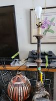 Full view of the metal floor lamp with bulb socket and heavy base.