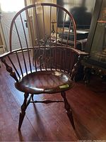 Front view of chair showing curved spindle back and contoured seat