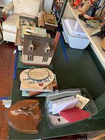 Overview of multiple frames, inspirational plaques, note paper, handmade birdhouse shaped item on table