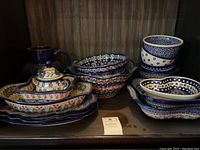 Full shelf view showing assortment of bowls, pitchers, sugar bowl and platters