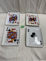 Four ceramic platter plates featuring playing card faces: Queen of Hearts, King of Diamonds, Jack of Spades, and Ace of Clubs shown on a neutral background.