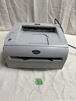Front view of the Brother HL-2040 laser printer with power cable