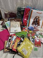 Wide view of assorted new gift bags and gift tags in multiple colors and designs.