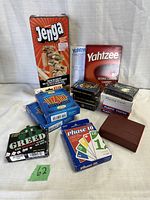 Full lot showing Jenga, Yahtzee refill, various card games including Greed, Phase 10, Wizard, and deck boxes