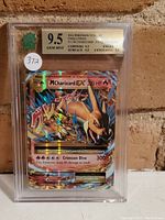 Front view of the graded M Charizard EX card showing the holographic artwork and grade label.
