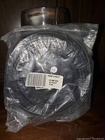 Coiled HDMI cable sealed in plastic with visible label stating 10 meters (33 feet) length.
