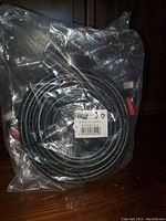 Full view of the coiled HDMI cable inside sealed clear plastic packaging with label showing barcode and specification details.