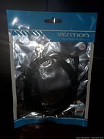 Front photo showing the Vention branded sealed plastic bag containing the USB to Mini 5-Pin cable.