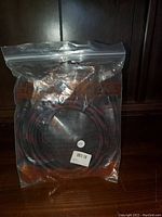 Full view of VGA cable in resealable plastic bag showing braided cable and packaging details.
