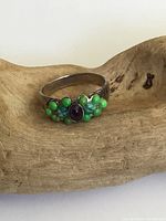 Ring front and front top view showing amethyst center stone with green turquoise and agate beads and sterling silver band.