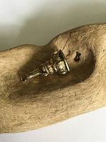 Side angle showing ornate, detailed gold fob body and non-gold swivel piece.
