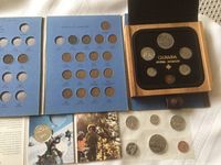 Photo of collectible Canadian coins in blue display booklet and several loose coins laid flat.