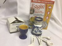 Image showing Eggies Hard Boil Eggs kit box, Thunder Group single cup coffee filter box, ceramic egg cup, ceramic decorative container, and measuring spoons.