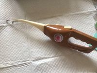 Side view of the Pocket Fisherman fishing rod showing the handle, reel integration, and rod tip with line guide.
