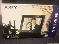 Box front showing Sony 9" DPF-V900 S-Frame digital photo frame with couple image on display.