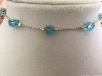 Close-up showing light blue turquoise cube crystals and fine silver chain of ankle bracelet.
