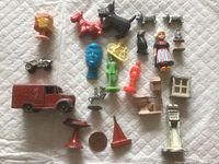 Full group of various very old lead miniatures laid on a cloth, showing the paint condition and variety of items including vehicles, animals, human figures and household objects.