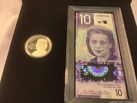 Interior of presentation case showing silver coin capsule on left and $10 note in clear holder on right