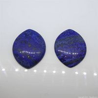 Two marquise cabochon Lapis Lazuli gemstones placed side by side showing their shape and surface finish.