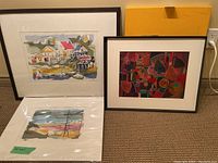 Group view of the three abstract artworks showing two framed pieces and one unframed print on floor.