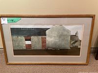 Framed artwork showing 'The Stone Barn' stone barn image with wooden frame and beige matting.