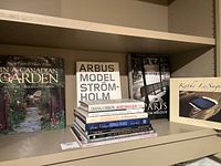 Books arranged on shelves showing spines and some cover fronts with photographic and gardening themes.