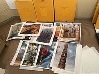 Photo showing assorted 16x20 photographic prints laid out on floor, capturing diverse subjects and themes by professional photographer Kelsey Mason.