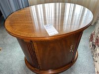 Top view showing the smooth polished oval wooden surface with a tag on it.