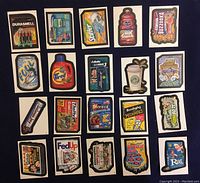 Front view of all 20 Wacky Packages stickers laid out in a grid showing the parodied consumer product graphics with visible wear and edge fraying.