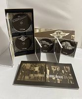 Four Doobie Brothers CDs in jewel cases, with boxed set packaging and booklet opened showing the band photos and title Long Train Runnin The Doobie Brothers 1970-2000