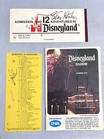 Photo showing the Disneyland Admission ticket, child's ride ticket with ride listings, and Disneyland Summer 1972 Guide booklet with fireworks cover.