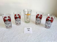 Five glasses on table, including four Kentucky Derby 2001 glasses with red roses and one James Bond DR NO glass with gold lettering.