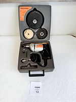 Top view of vintage Black & Decker power drill kit in molded carrying case, showing drill and accessories.