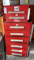 Front view of stacked red metal tool storage modules with American Airlines logos and silver tray on top