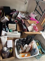 Wide view of assorted beauty and personal care items scattered on the floor