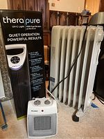 Kenwood radiator heater, Pelonis space heater, Therapure air purifier box and unit grouped in a room