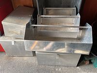 Overall view of three all-aluminum airline mechanic tool totes and three metal storage boxes stacked together.