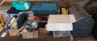 Wide view of the lot showing tools, extension cord, telescope, and toolboxes on the floor.