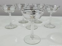 Front view of the 5 frosted leaf champagne glasses showing the squared stem and rim details.