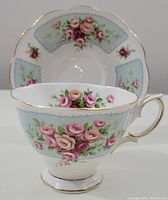 Photo showing both the Royal Albert cup and saucer with pink rose design and gold trim