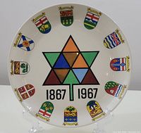 Front view of 1967 Canadian Centennial collectible plate featuring colorful maple leaf design and Canadian provincial coats of arms around the rim.