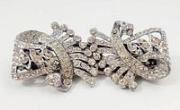 Front view of the silver-tone rhinestone brooch showing the detailed abstract design with clear rhinestones.
