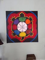 Square painting with symbolic colored sections in green, orange, red, brown, yellow, blue, and purple on black background, each representing one of the seven Native Grandfather Teachings. Artwork by Ojibway artist Malinda Jane measuring 3ft x 3ft.