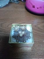 Copper filigree brooch with embedded natural pearls and matching copper and pearl earrings in a box