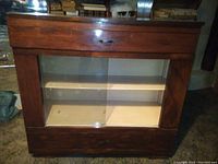Vintage wooden buffet cabinet with glass display case, top drawer, and lower compartment door.