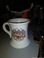 Single white ceramic mug with Prince Charles and Lady Diana portraits and decorative royal design on front, commemorating their wedding date.