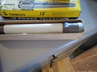 Vintage Tasco 10 Power Zoom Telescope in original box, showing telescope body, eyepiece, and packaging.