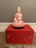 Figurine and red presentation box, front view