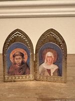 Front view of the religious icon with the two painted saint panels and decorative gold-tone frames.